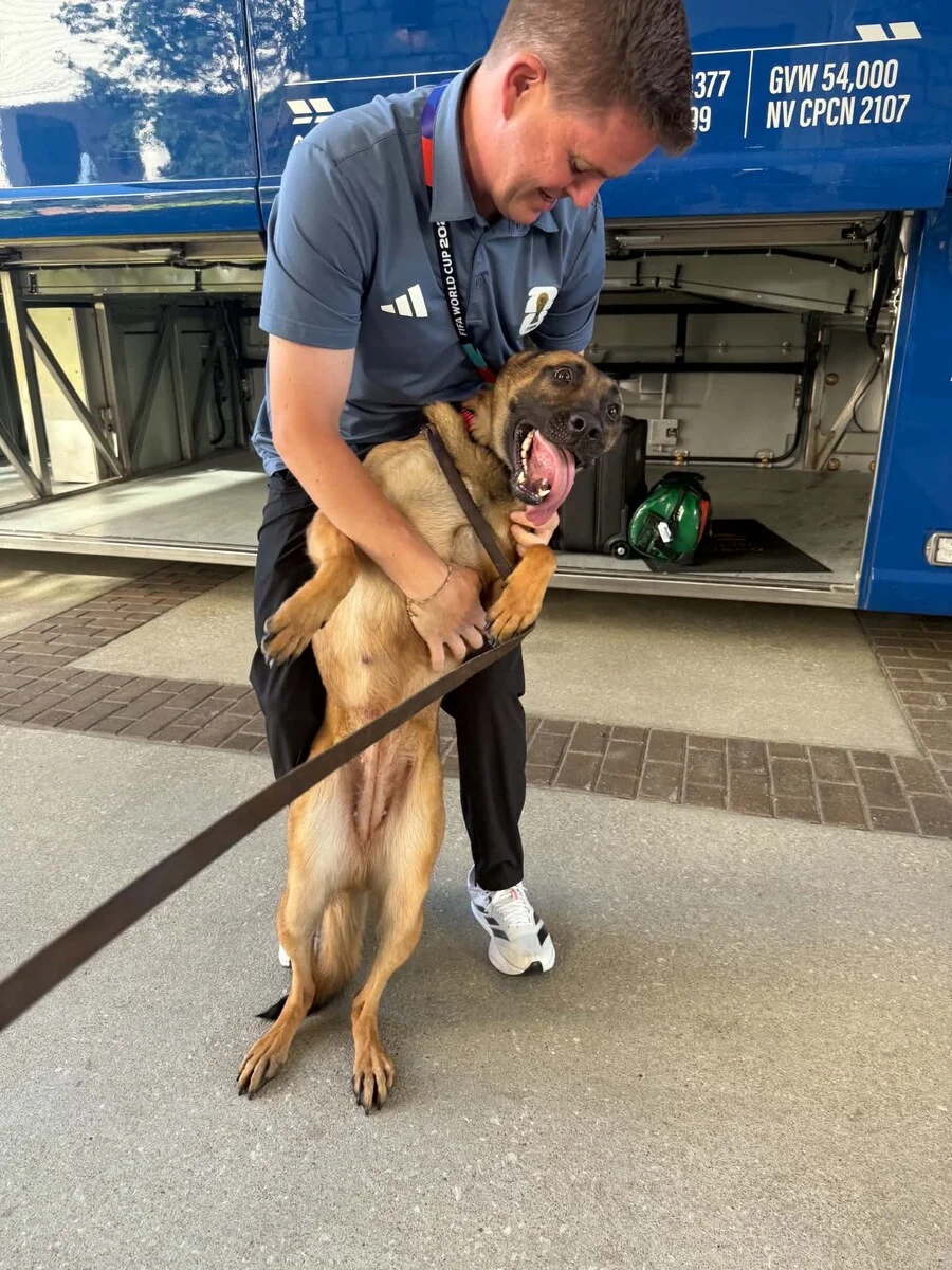 K9 handler with detection dog at public venue